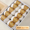 A box filled with ten balls of Merino wool yarn, labeled as 10 pieces equal to 500 grams.