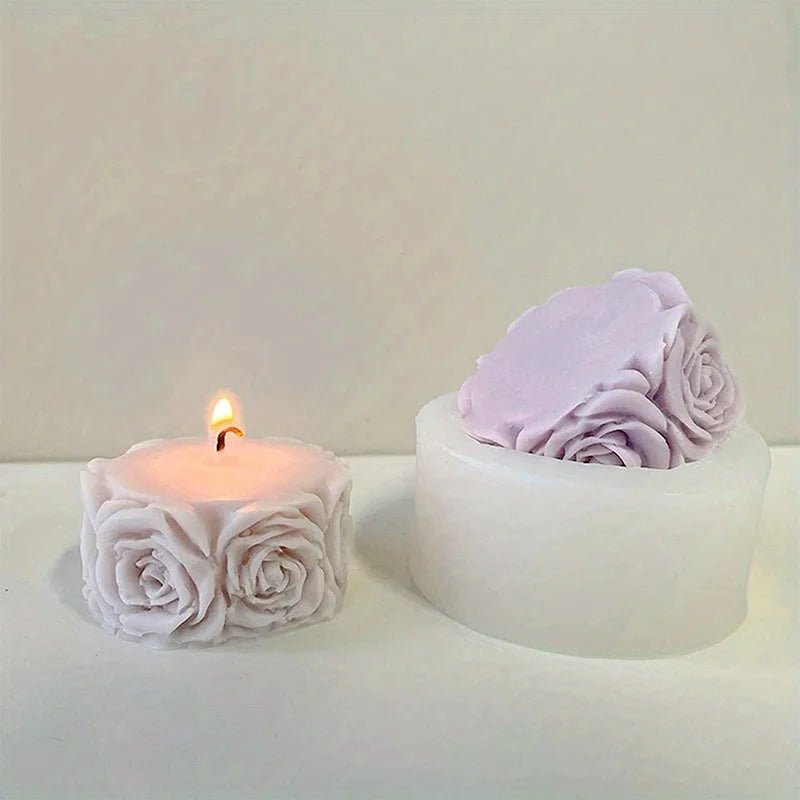 A white silicone rose candle mold with a pink rose candle inside.