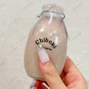 A hand holds a clear bottle containing a squishy fidget toy labeled Chiboki.