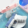 A pink and white high-pressure water blaster is shown resting on a blue, watery surface.