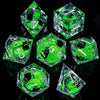 A set of green liquid core resin dice shaped like pyramids and hexagons, displayed on a reflective black surface.