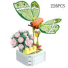A set of 226 plastic rose flower building blocks forming a bouquet in a white container.