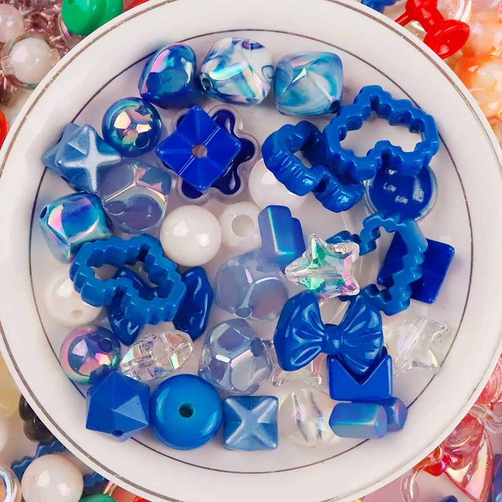 A collection of blue and iridescent acrylic bow and flower beads for DIY jewelry making