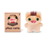 A small brown plush toy of a furry monster with large green eyes and pink accents, displayed next to its packaging.