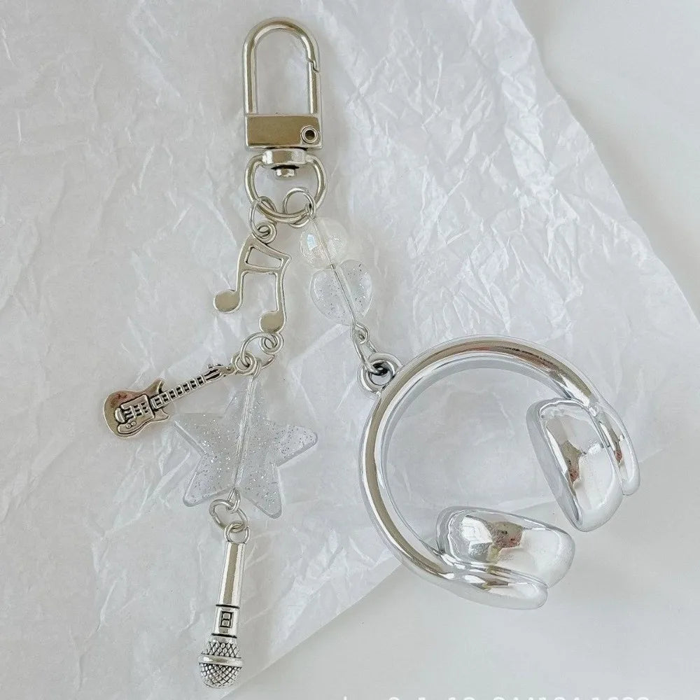 Silver beaded wing cross phone lanyard keychain with a clear circular loop and a microphone attachment