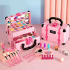 A pink princess pretend play makeup set with various cosmetic items and brushes displayed on a light pink surface.