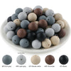 A collection of soft silicone round beads in various shades including gray, brown, and black.