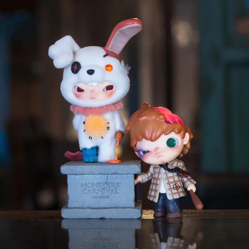A collectible figure of a white monster with pink ears and an orange-yellow belly stands on a gray pedestal.