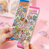 A hand holds a colorful 12-pack of 3D landscape stickers featuring Japanese-style buildings and scenes.