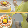 A child interacts with an interactive bouncing duck toy, which is yellow and white, in a bright kitchen setting.