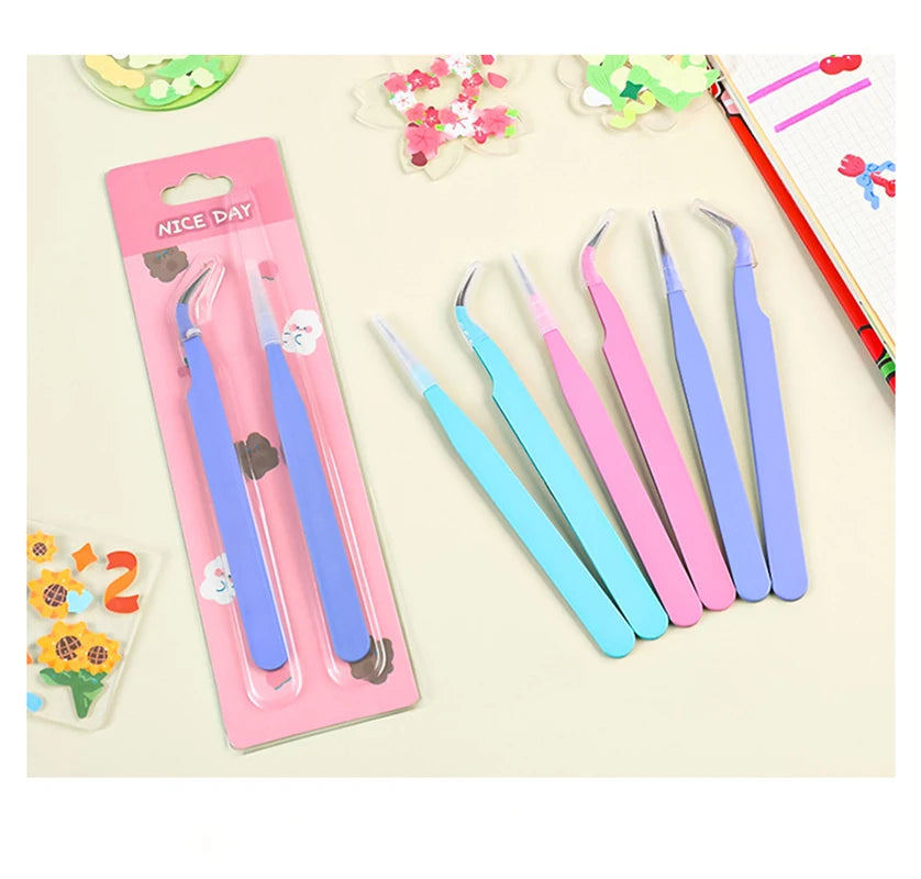 A set of precision stainless steel tweezers in various shades of purple and blue packaged for nail art and makeup.