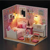 A pink miniature dollhouse featuring furniture, decor, and a bed set in a detailed puzzle kit.