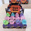 A collection of purple, green, and blue squeeze stress relief balls in Halloween-themed packaging.