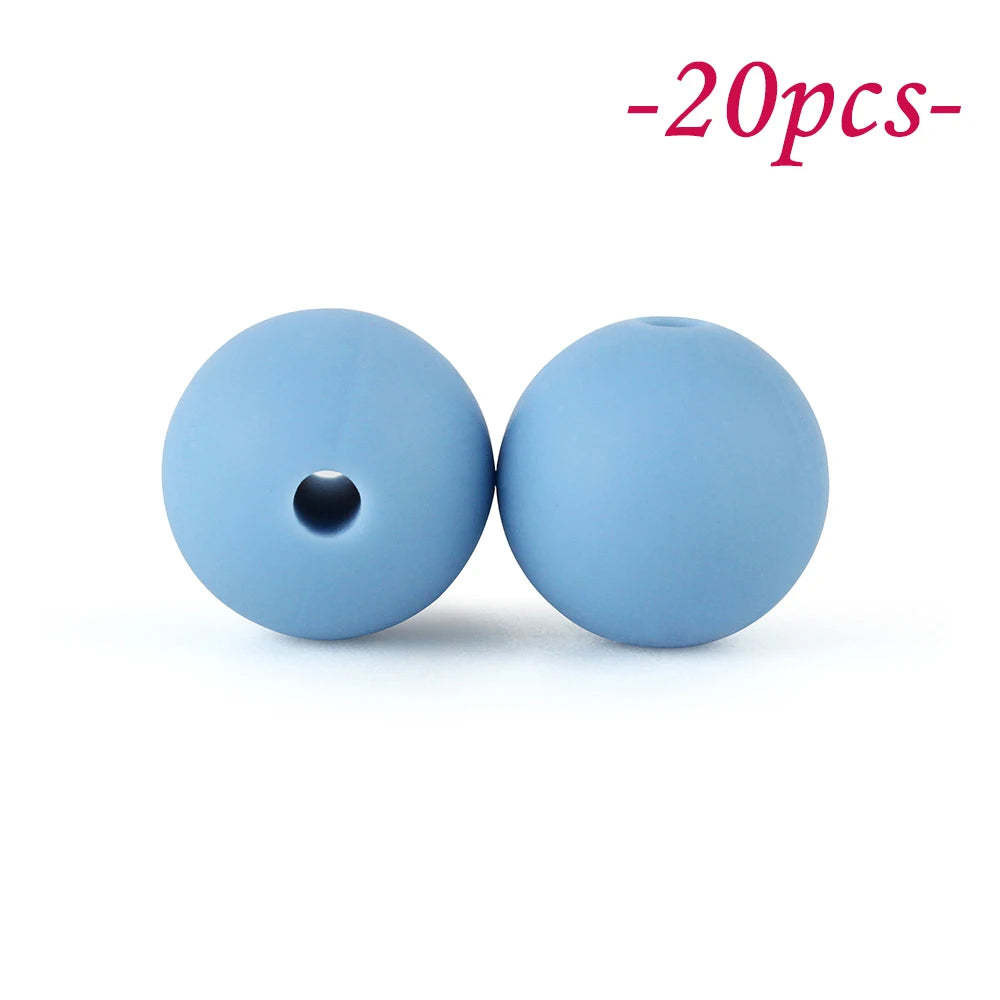 Two light blue silicone beads are shown against a white background.