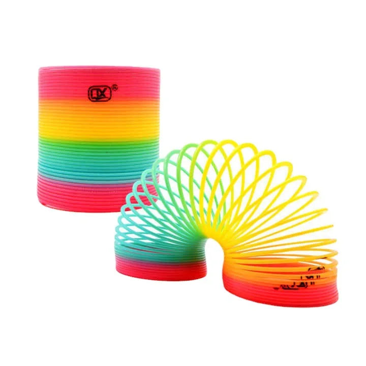 A colorful spring circle toy with rainbow stripes, demonstrating hand-eye coordination.