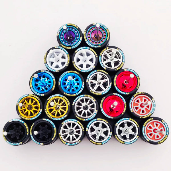 A collection of 12 automotive scale car wheels and tires arranged in a pyramid formation.
