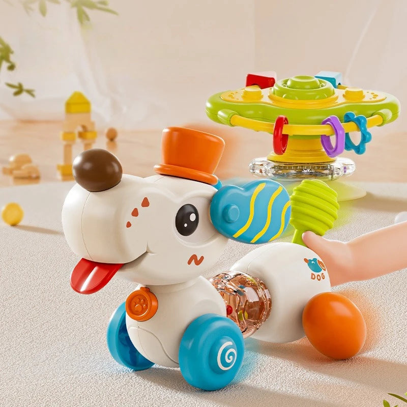 A white cartoon baby rattle toy shaped like a dog with orange and blue accents sitting on a light surface.