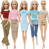 Five dolls wearing various casual outfits including pink, blue, and striped tops with skirts and jeans