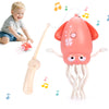 Un jouet de pieuvre rose interactif avec des tentacules et une baguette claire, à côté d'un bébé.