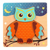 A wooden owl puzzle featuring bright orange and teal colors against a blue background with stars and a crescent moon.