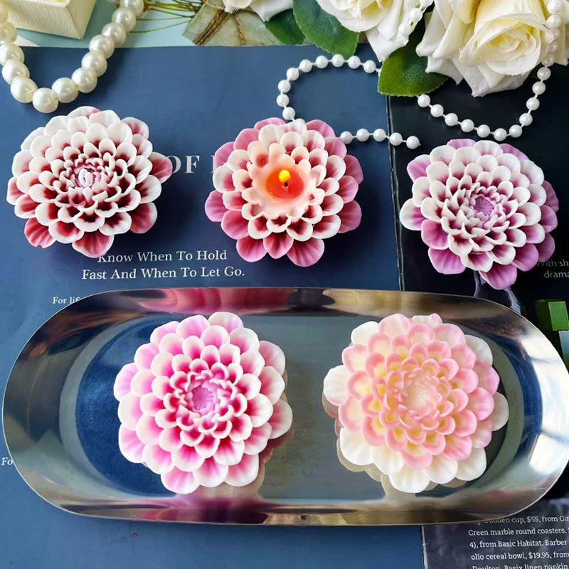 Pink and white flower silicone molds for candle, soap, and resin crafting displayed on a blue surface.