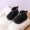 A pair of black faux fur winter snow boots for toddlers resting on a white fabric surface.