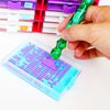 A hand holds a green diamond art pen with interchangeable tips over a clear plastic kit.