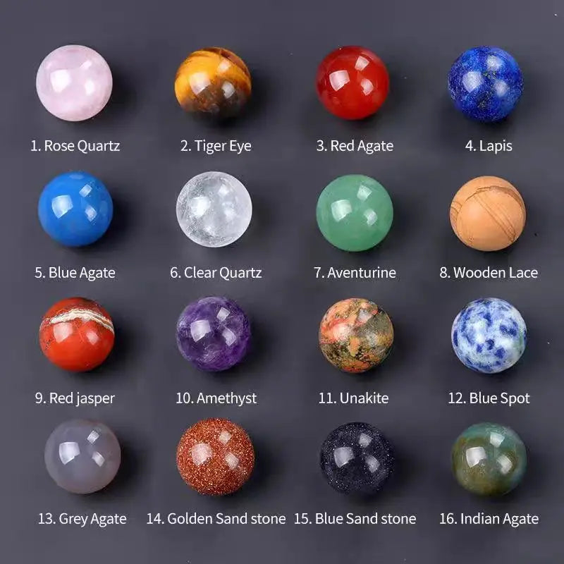 A collection of sixteen polished crystal spheres including Rose Quartz, Tiger Eye, Lapis, Agates, and other gemstone stones.