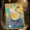 A collectible card featuring a winged unicorn in a vibrant, celestial design against a dark background.