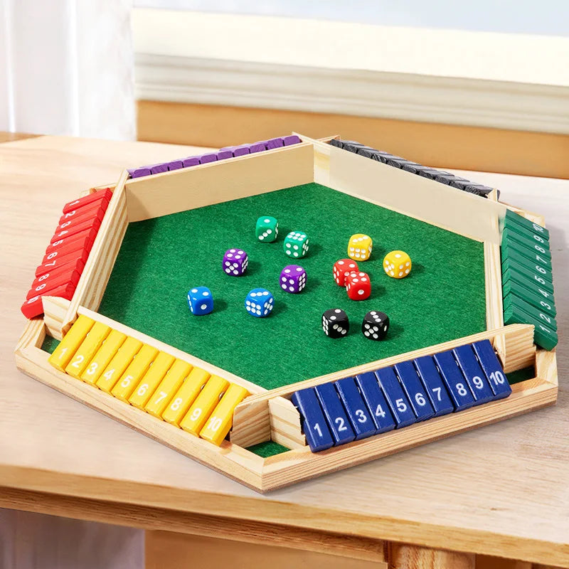 A wooden shut the box dice game with green felt board and colored dice arranged in compartments.