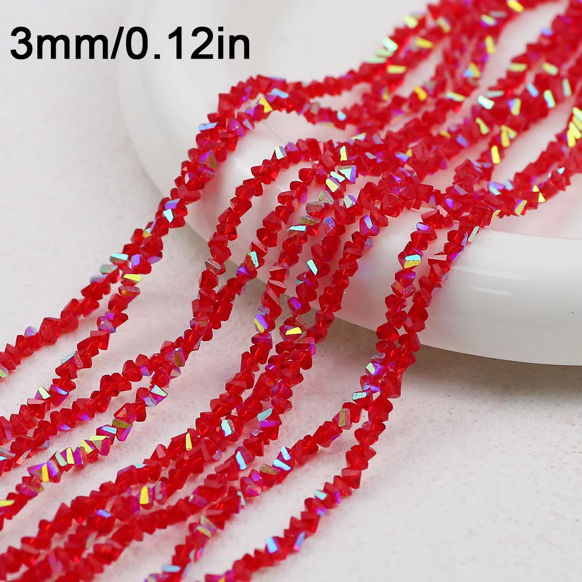 Red crystal triangle beads measuring 3mm or 0.12 inches arranged in strands for jewelry making