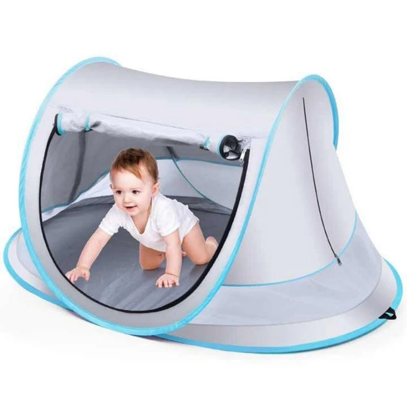 A baby tent is shown open, featuring a breathable mesh interior and a light gray fabric canopy.