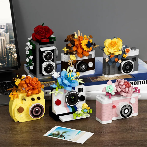 A set of building blocks depicting a retro SLR camera with floral accents and various accessories.