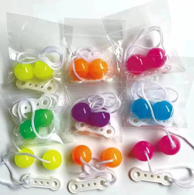 Clear bags of colorful click clack stress relief fidget balls on a string