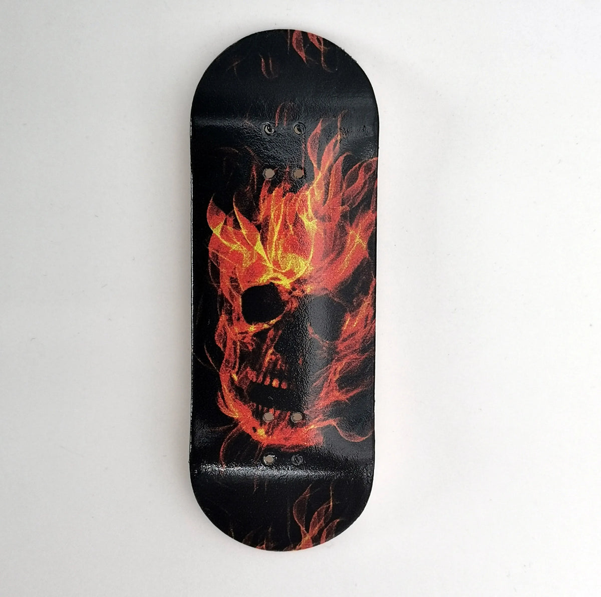 Black skateboard deck with a UV-printed graphic of a flaming skull.
