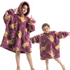 A young girl models a purple and gold fuzzy hoodie sweater for kids.