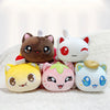 A collection of five plush cat dolls with various food accessories resting on a white textured surface.