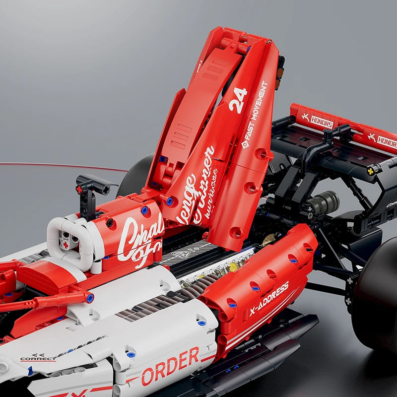 A red and white 1:8 scale formula racing car building blocks set with steering and engine linkage.