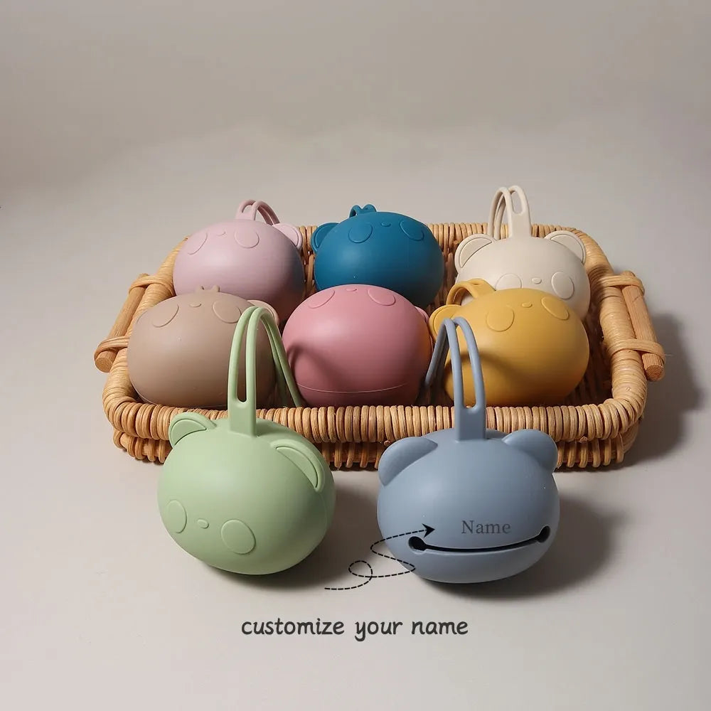 A collection of food-grade silicone panda-themed pacifier storage bags in various pastel colors, including pink, blue, yellow