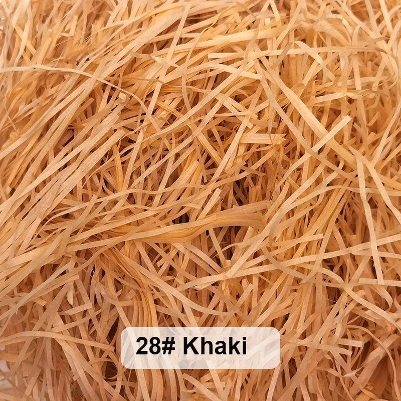 Pile of light brown khaki raffia paper shreds for gift boxes and baskets