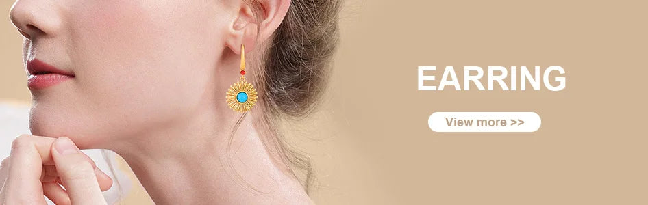 A close-up of a woman wearing a gold and blue teardrop earring.