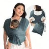A woman is wearing an X-shaped baby sling carrier with multifunctional back support, demonstrating its use.