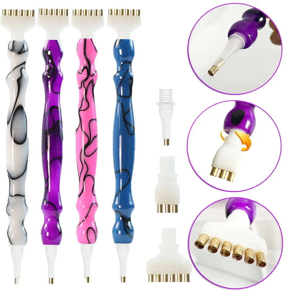 A set of diamond painting pens with interchangeable tips in purple, pink, and blue colors shown against a white background.