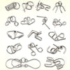 A collection of various metal wire puzzles and brain teasers for IQ challenges.