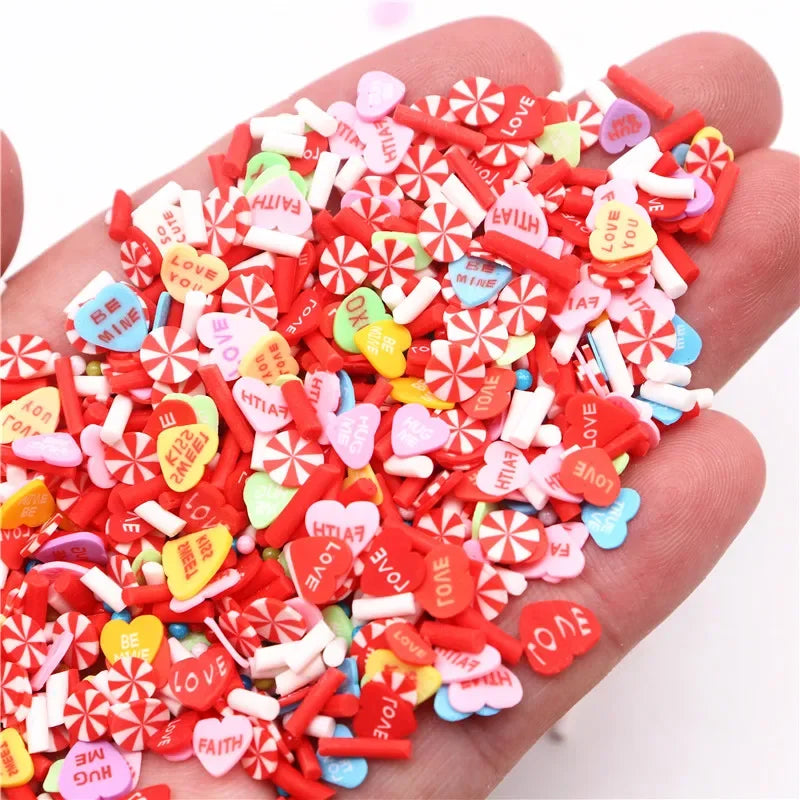A hand holds a pile of assorted polymer clay slices in various colors including red pink and white for DIY crafts