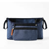 Navy blue fabric organizer bag for strollers featuring a zippered pocket and hanging hooks
