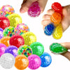 A variety of colorful soft rubber stress balls in various shades including pink, yellow, green, orange, and blue are shown be