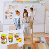 A set of magnetic letters and numbers for kids displayed on a table with wooden chairs in a bright room.