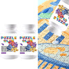 Two bottles of clear puzzle preserving glue with purple and blue labels shown next to a jigsaw puzzle background