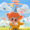 An orange-haired chibi-style figurine of a girl with pink hair wearing a party hat, standing in a grassy field.